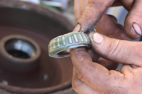 Mechanic lubricate a roller bearing with lithium grease